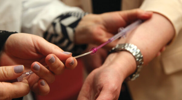 Nurse drawing blood from patient