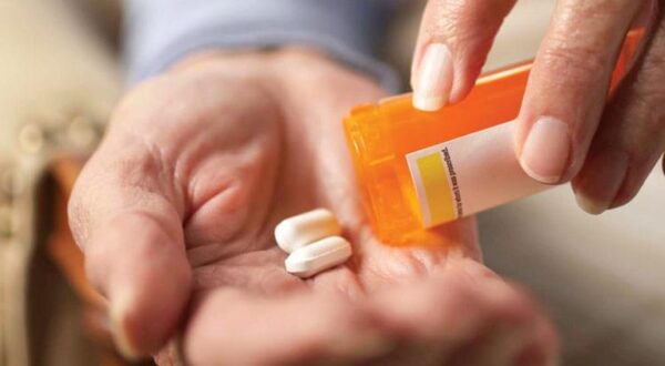 pills from a pill bottle being poured into a hand